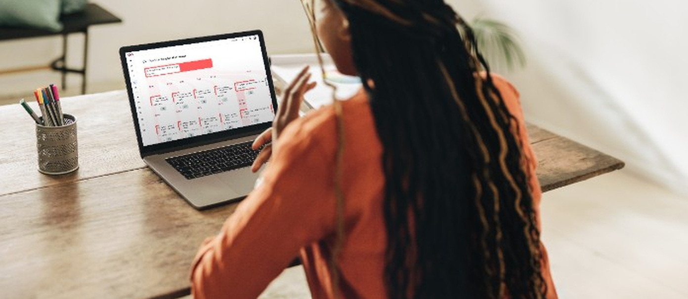 Content designer working at a laptop in a bright workspace